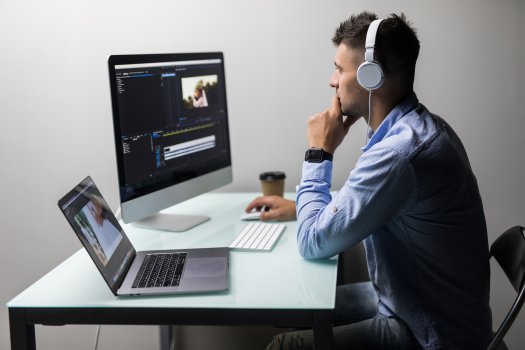Man editing video on laptop